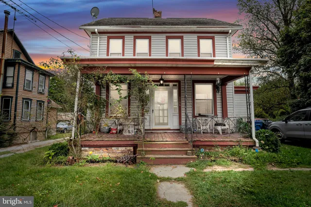 a house view with outdoor seating space and garden