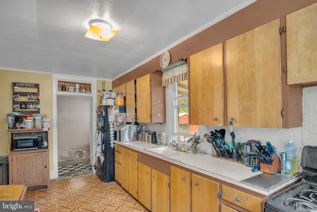 a view of kitchen with stainless steel appliances a sink and a window