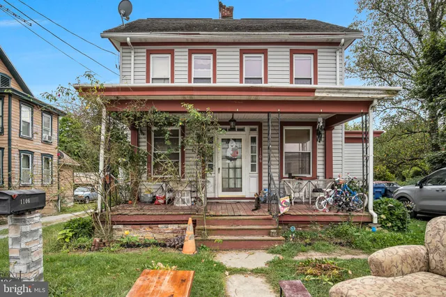 a front view of a house with a garden and plants