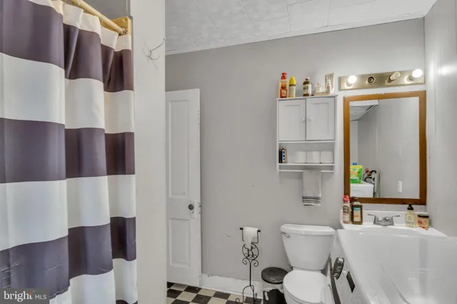 a living room with furniture and a mirror