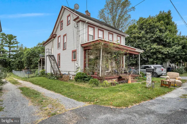 a view of a house with a yard and sitting area