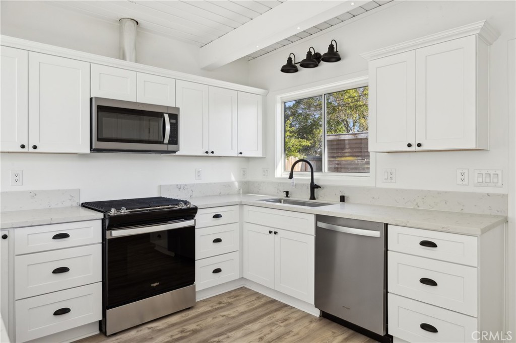 528 Creston Road Paso Robles, CA 93446 - Photo 28 of 46 a kitchen with cabinets appliances a sink and a window