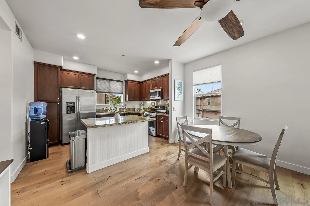 2710 Sparta Road, Unit 1 Chula Vista, CA 91915 - Photo 14 of 45 a kitchen with a table chairs refrigerator and microwave