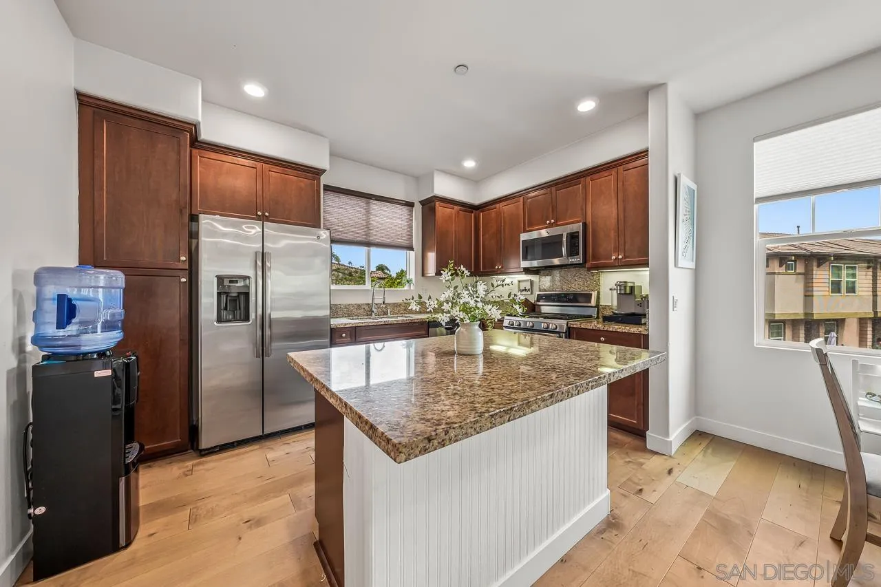 2710 Sparta Road, Unit 1 Chula Vista, CA 91915 - Photo 15 of 45 a kitchen with stainless steel appliances granite countertop a refrigerator a stove and a sink with wooden cabinets