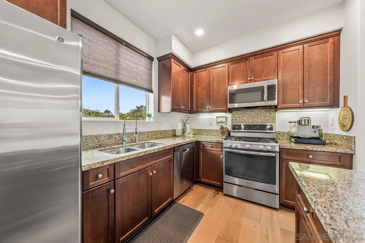 2710 Sparta Road, Unit 1 Chula Vista, CA 91915 - Photo 19 of 45 a kitchen with kitchen island granite countertop a sink stove and cabinets