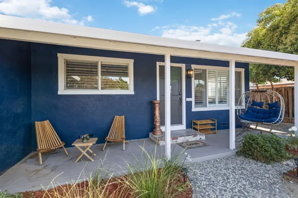 a view of a house with outdoor seating area