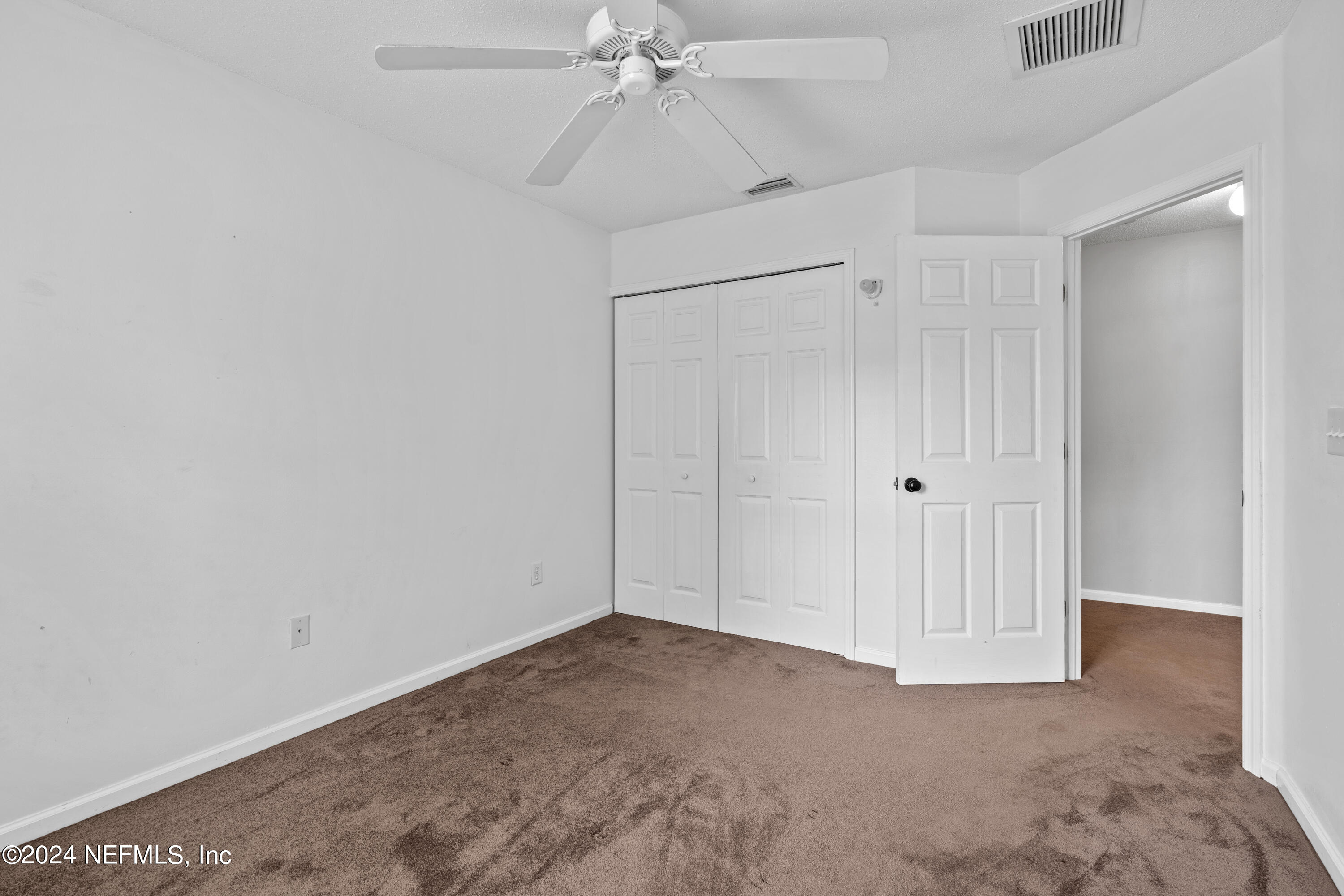 86701 Cartesian Pointe Drive Yulee, FL 32097 - Photo 22 of 36 a view of a room with an empty space and a ceiling fan