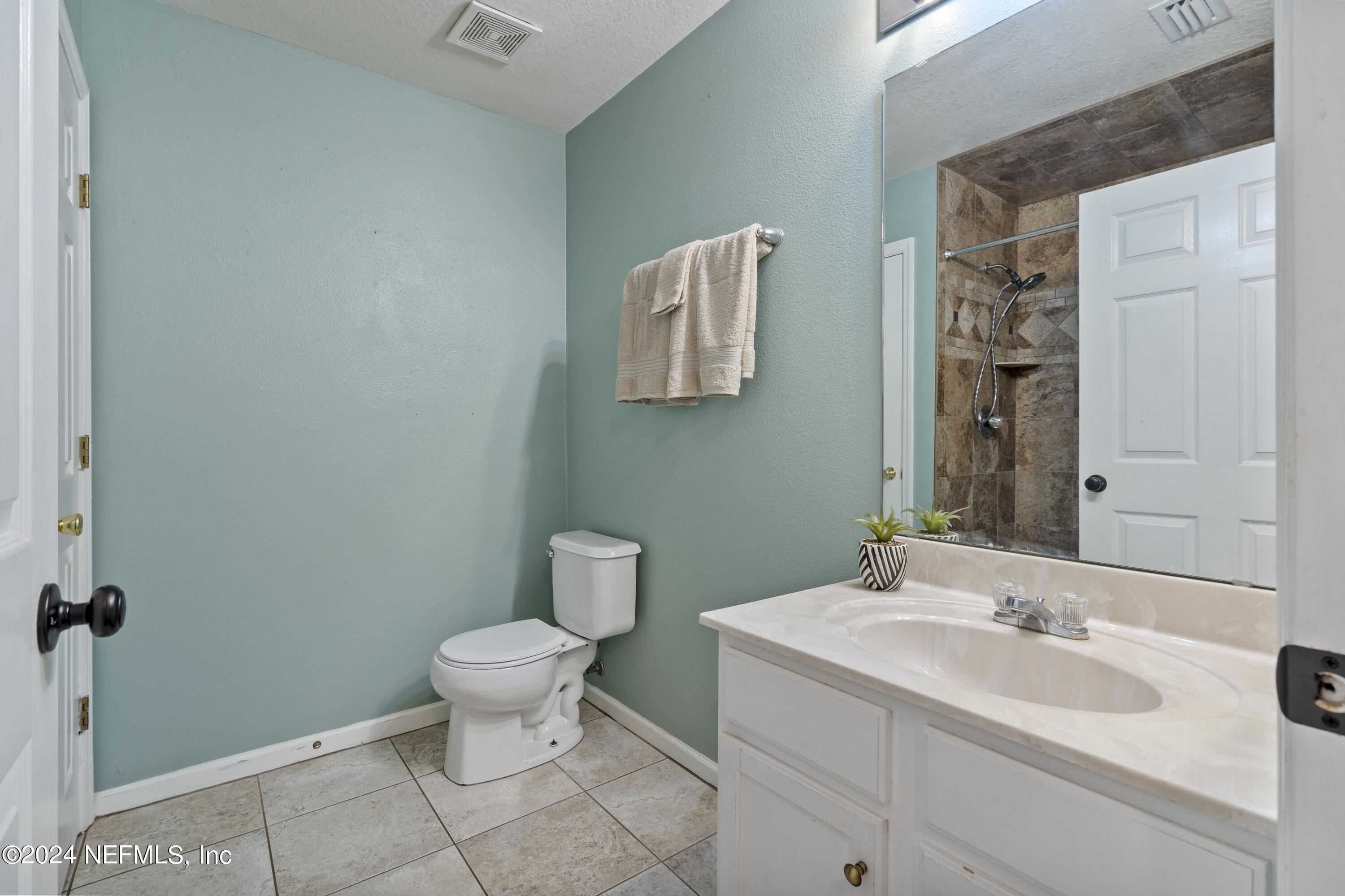 86701 Cartesian Pointe Drive Yulee, FL 32097 - Photo 23 of 36 a bathroom with a toilet sink and mirror