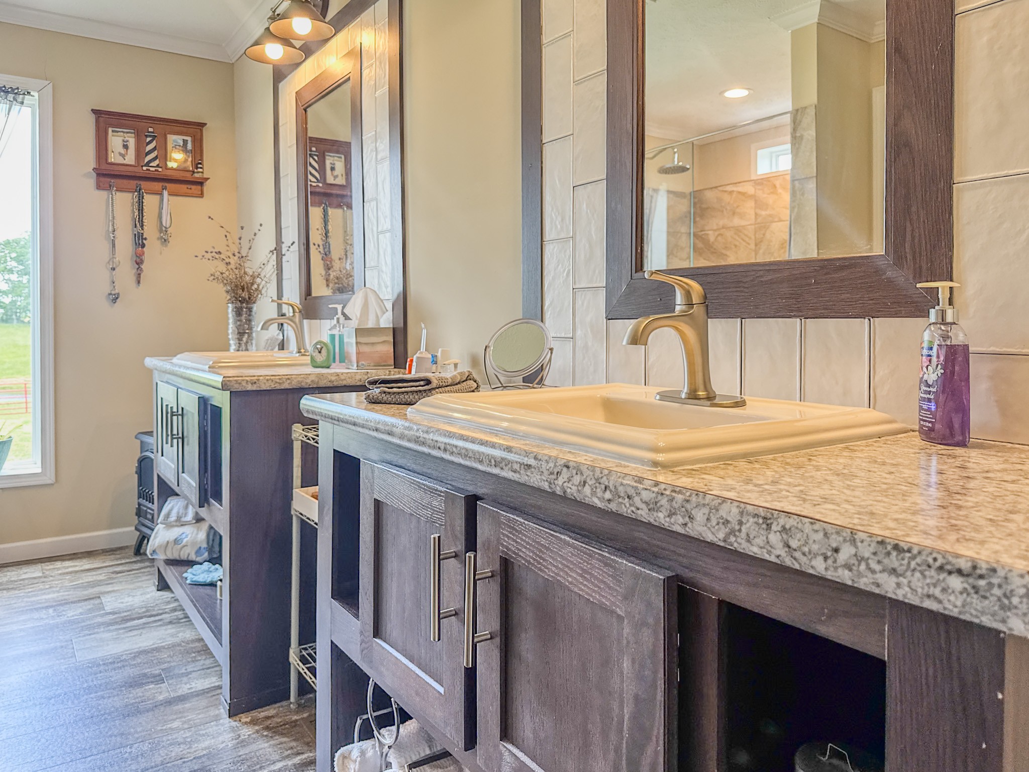 1198 David Patterson Road Lutts, TN 38471 - Photo 23 of 82 a bathroom with a granite countertop sink a mirror and a window