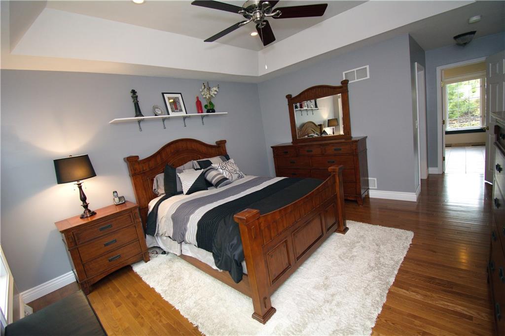 425 Rolling Hills Road Freedom, PA 15042 - Photo 11 of 25 The owner's suite features modern tones and hardwood flooring.