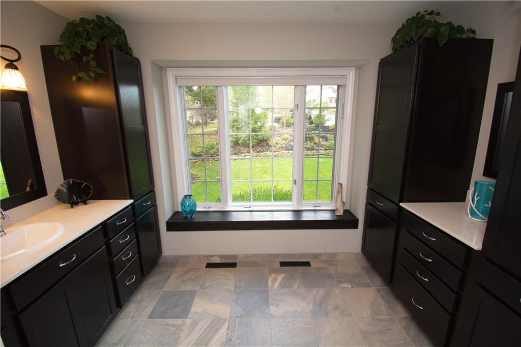 425 Rolling Hills Road Freedom, PA 15042 - Photo 12 of 25 Pamper yourself in the well lit spa like owner's bath featuring storage galore and ample Quartz counter space.