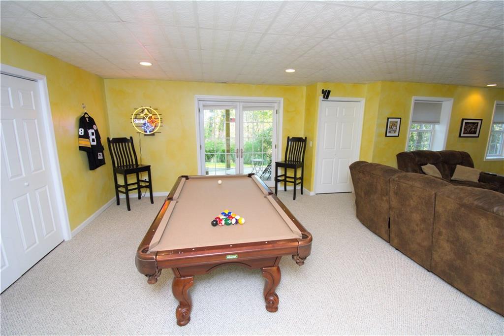 425 Rolling Hills Road Freedom, PA 15042 - Photo 19 of 25 The game room area features access to the lower patio and hot tub.