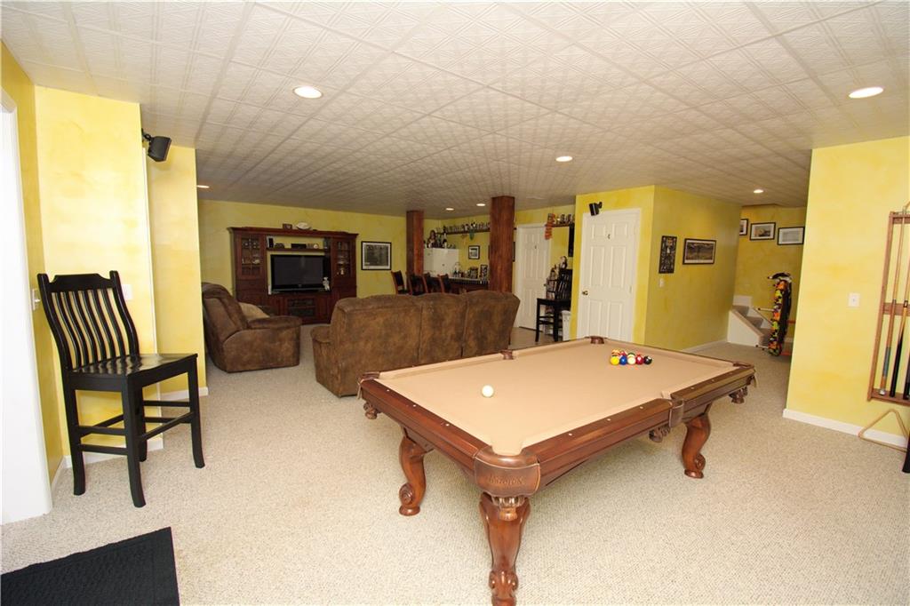 425 Rolling Hills Road Freedom, PA 15042 - Photo 20 of 25 The open layout of the lower level is ideal for entertaining, featuring a custom wet bar. game room area and a second family room.