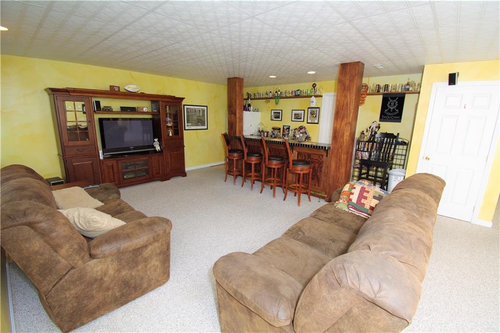 425 Rolling Hills Road Freedom, PA 15042 - Photo 21 of 25 The finished lower level is highlighted with a second family room and a custom wet bar.
