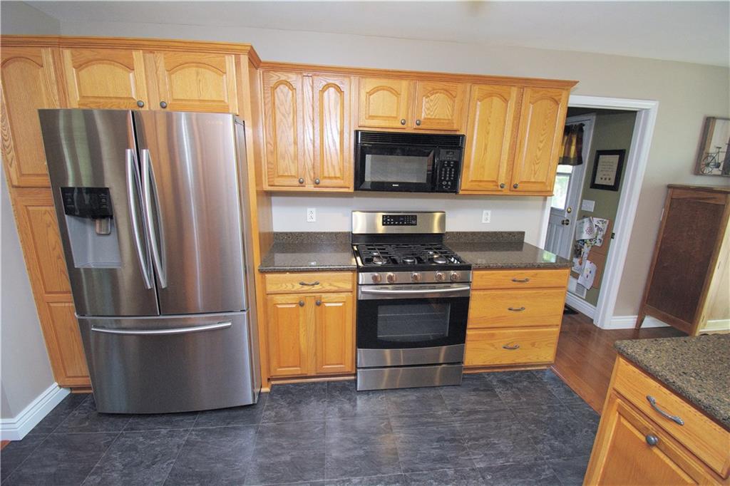 425 Rolling Hills Road Freedom, PA 15042 - Photo 7 of 25 Ample cabinetry and stainless steel appliances compliment the kitchen. The first floor laundry/family entrance, with access to the back deck, is adjacent to the kitchen.