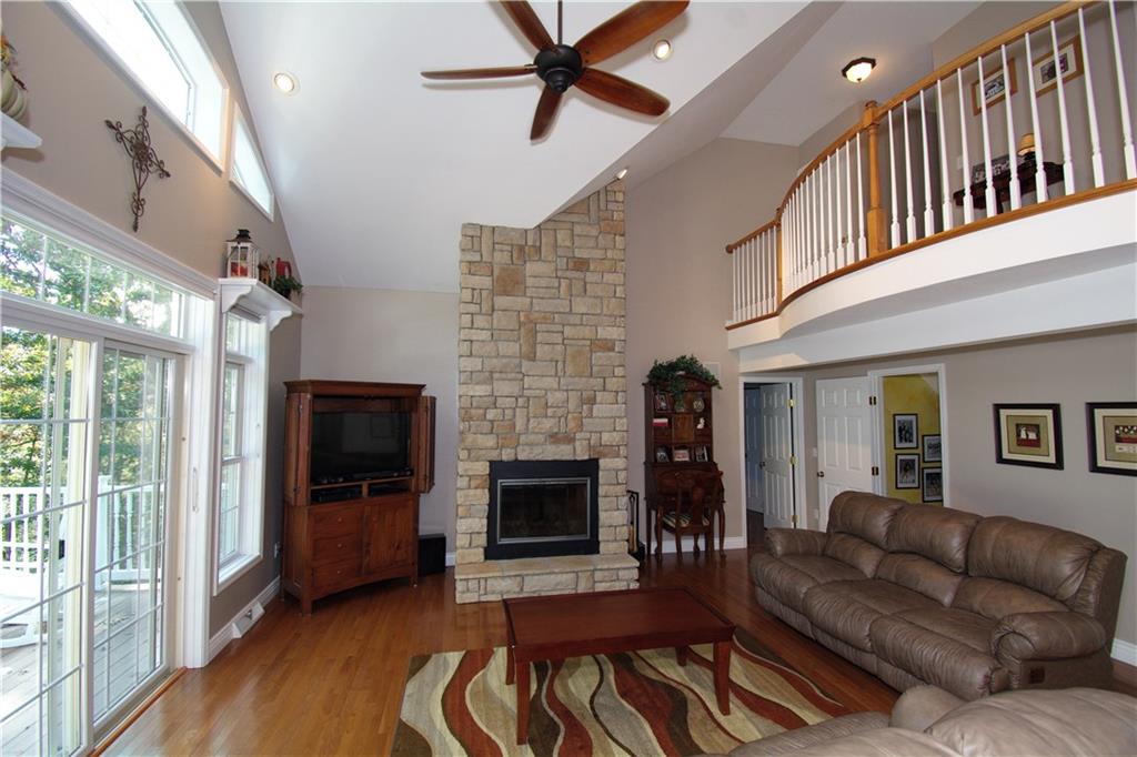 425 Rolling Hills Road Freedom, PA 15042 - Photo 8 of 25 Dramatic two story stone fireplace, hardwood flooring, neutral tones and bright windows showcase the serene views.