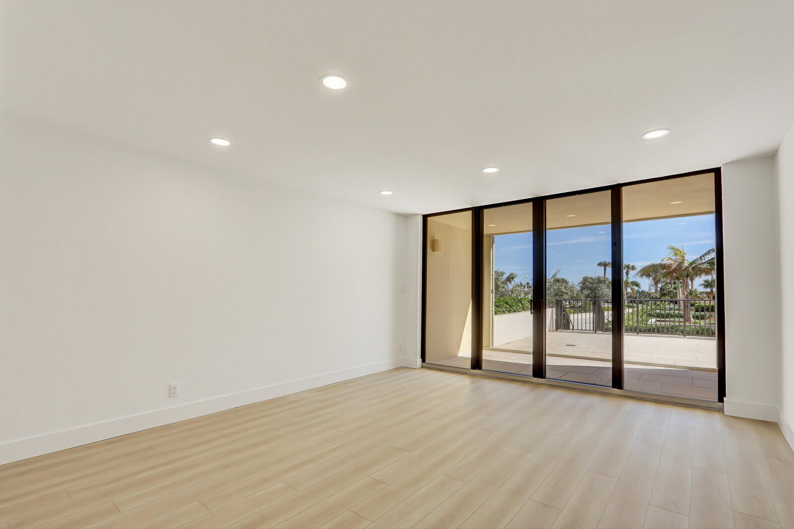 200 Ocean Trail Way, Unit T1 Jupiter, FL 33477 - Photo 11 of 39 a view of an empty room with wooden floor and a window