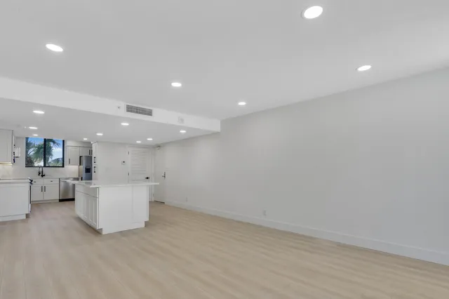 a view of kitchen and hall with wooden floor