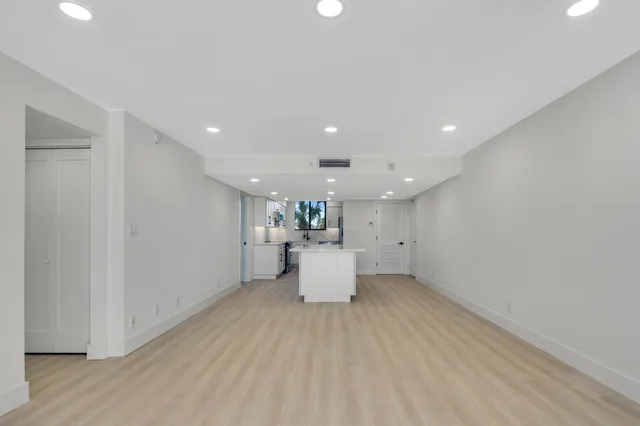 a view of a kitchen with a refrigerator and a window