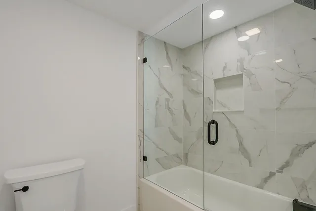 a bathroom with a bathtub and a shower