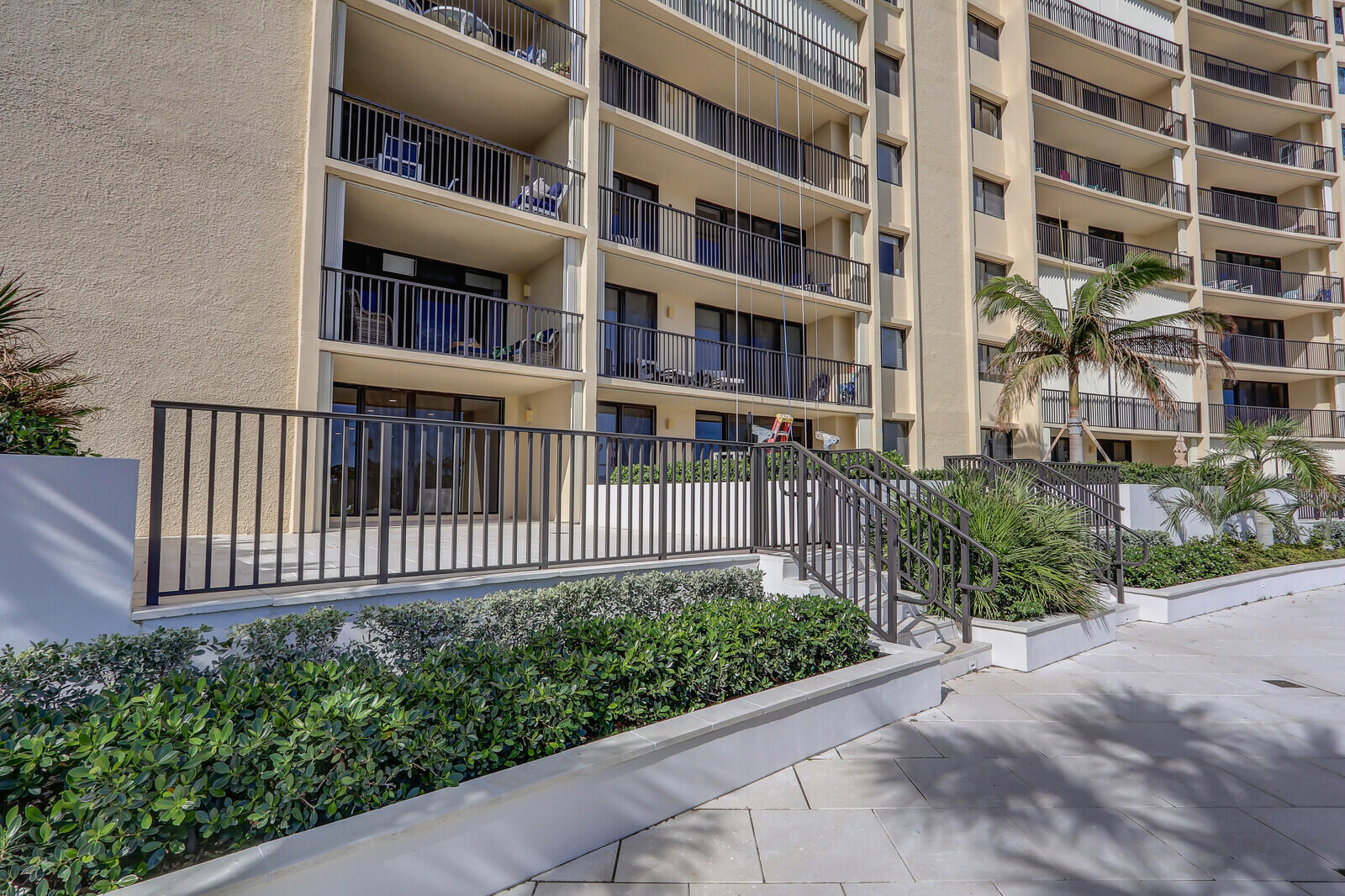 200 Ocean Trail Way, Unit T1 Jupiter, FL 33477 - Photo 5 of 39 a view of a brick building next to a yard