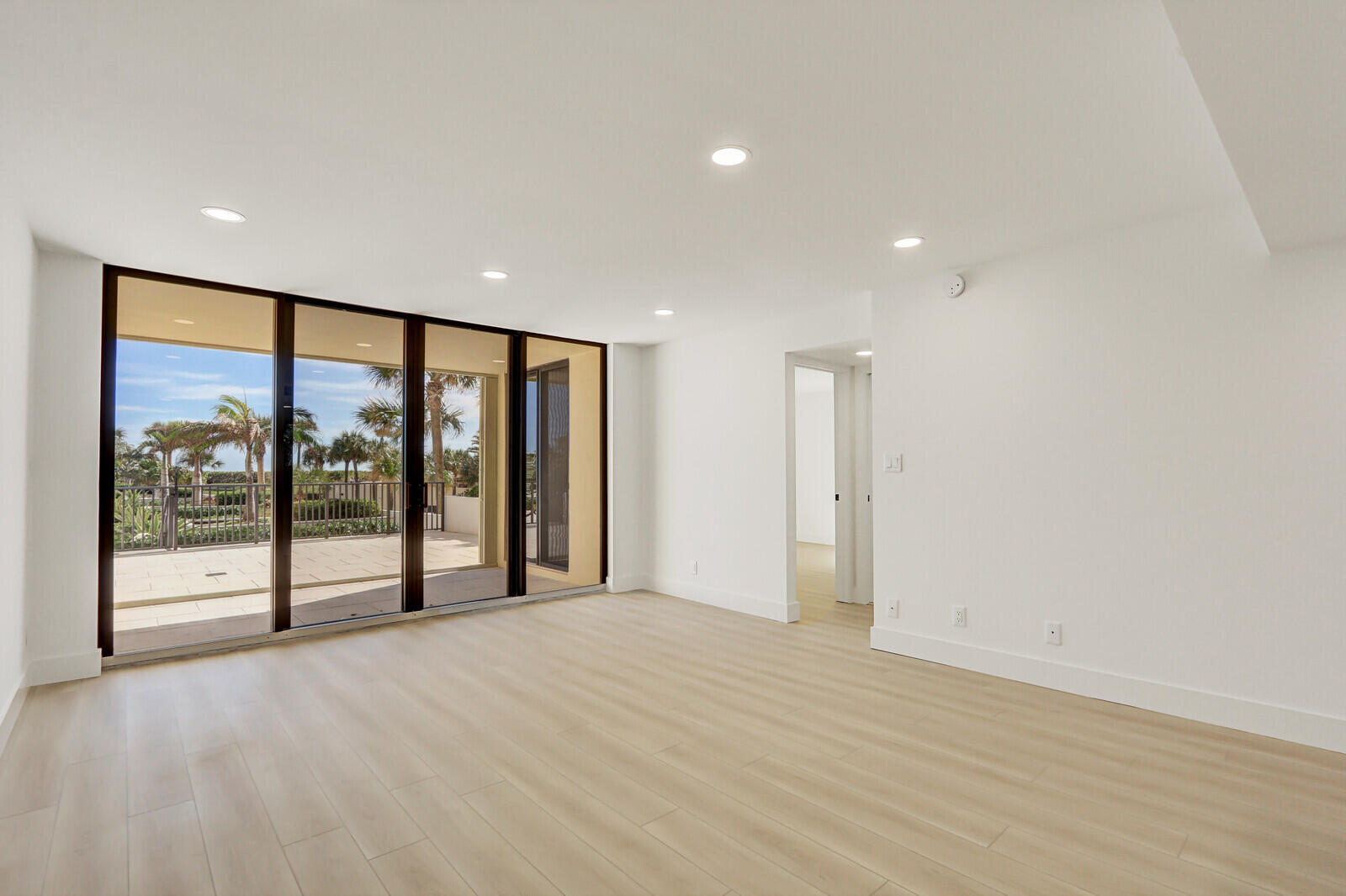 200 Ocean Trail Way, Unit T1 Jupiter, FL 33477 - Photo 9 of 39 a view of an empty room with wooden floor and a window