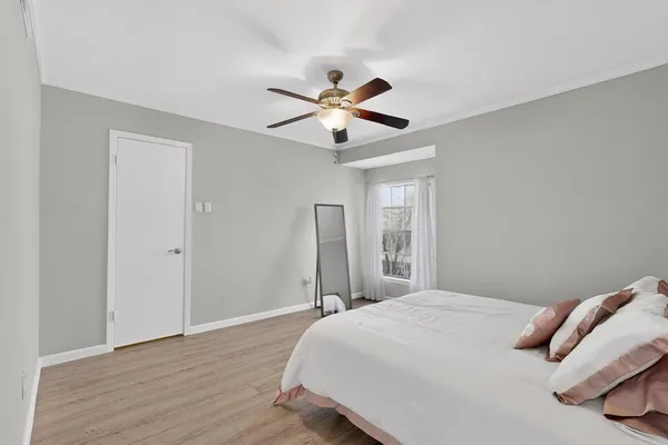 a bedroom with a bed and a chandelier