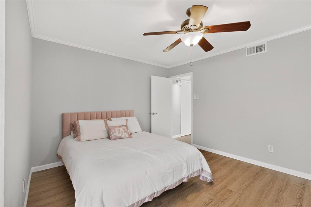5335 Bent Tree Forest Drive, Unit 237 Dallas, TX 75248 - Photo 17 of 33 a bedroom with a bed and a ceiling fan