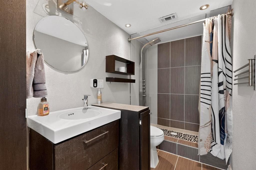 5335 Bent Tree Forest Drive, Unit 237 Dallas, TX 75248 - Photo 19 of 33 a bathroom with a sink toilet and shower