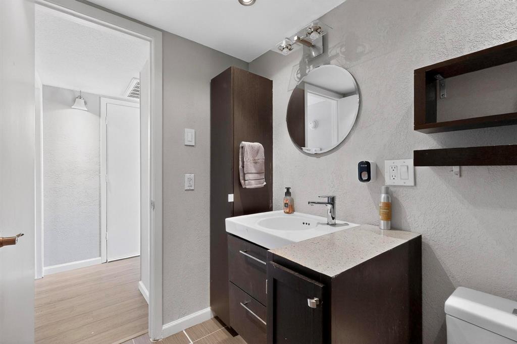 5335 Bent Tree Forest Drive, Unit 237 Dallas, TX 75248 - Photo 20 of 33 a bathroom with a sink and a mirror