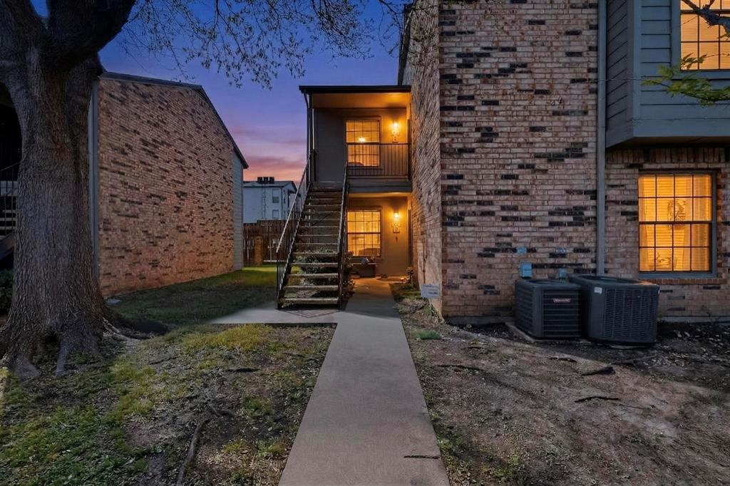 5335 Bent Tree Forest Drive, Unit 237 Dallas, TX 75248 - Photo 2 of 33 a view of a brick house with many windows