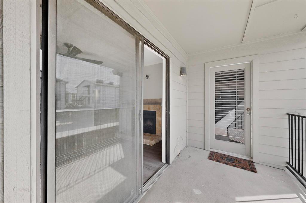 5335 Bent Tree Forest Drive, Unit 237 Dallas, TX 75248 - Photo 22 of 33 a view of a hallway with wooden shelves and entryway