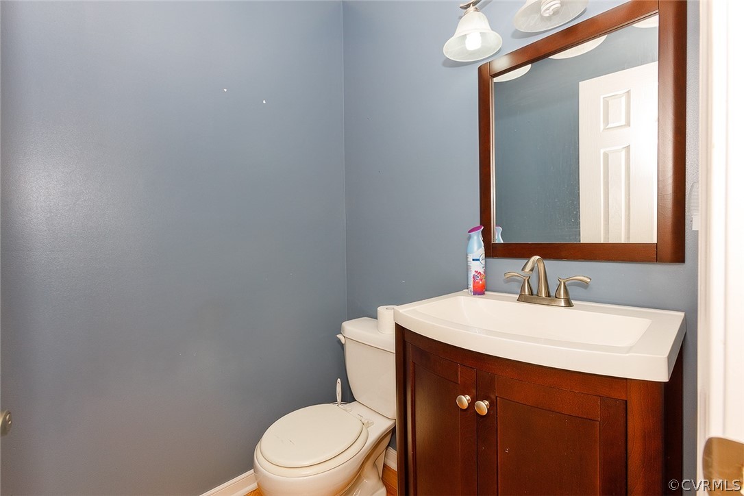 17301 Loving Union Road Disputanta, VA 23842 - Photo 18 of 31 a bathroom with a sink vanity mirror and toilet