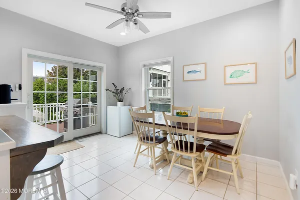 a dining room with furniture a chandelier and wooden floor