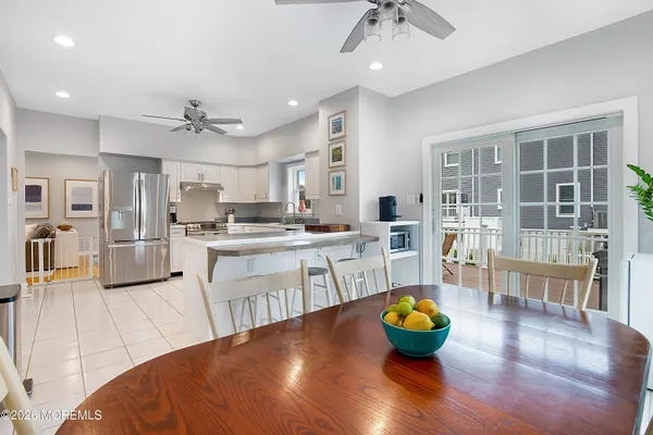 a kitchen with refrigerator and breakfast area