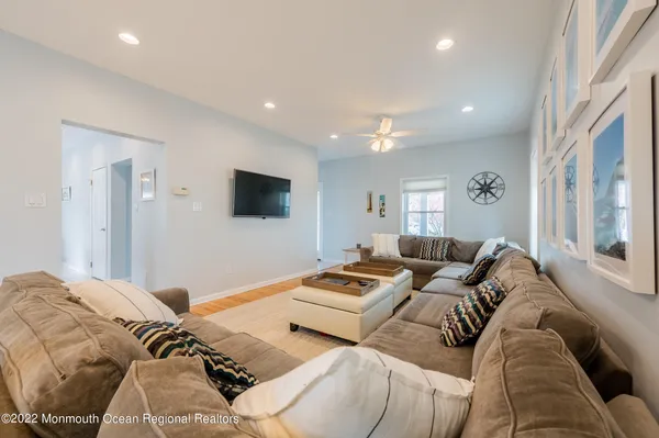 a living room with couches and a flat screen tv