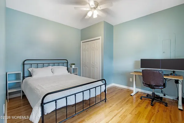 a bedroom with a bed a desk and chair