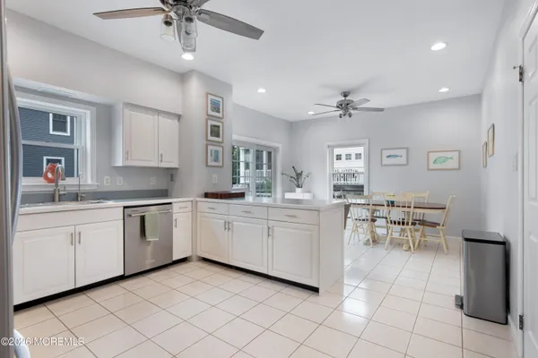 a kitchen with cabinets and chairs
