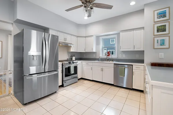 a kitchen with granite countertop a refrigerator oven a sink dishwasher and a refrigerator