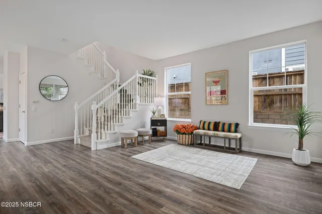 a living room with furniture window and wooden floor