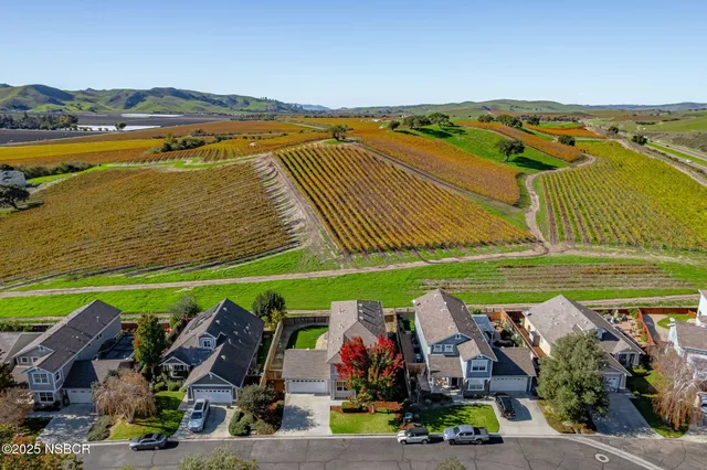 an aerial view of a house with a garden and outdoor seating