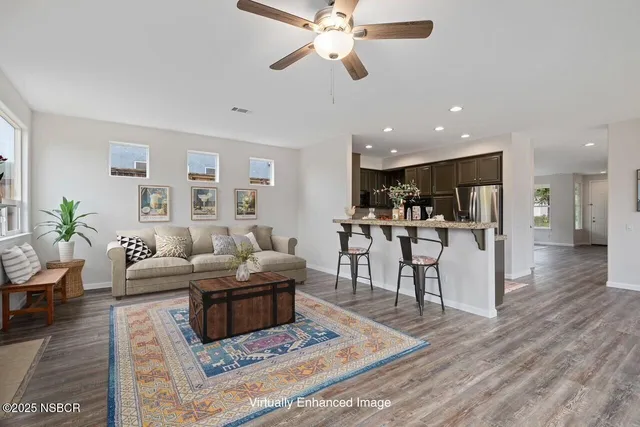 a living room with furniture and kitchen view