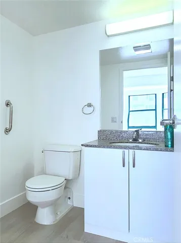 a bathroom with a granite countertop sink a mirror and a shower