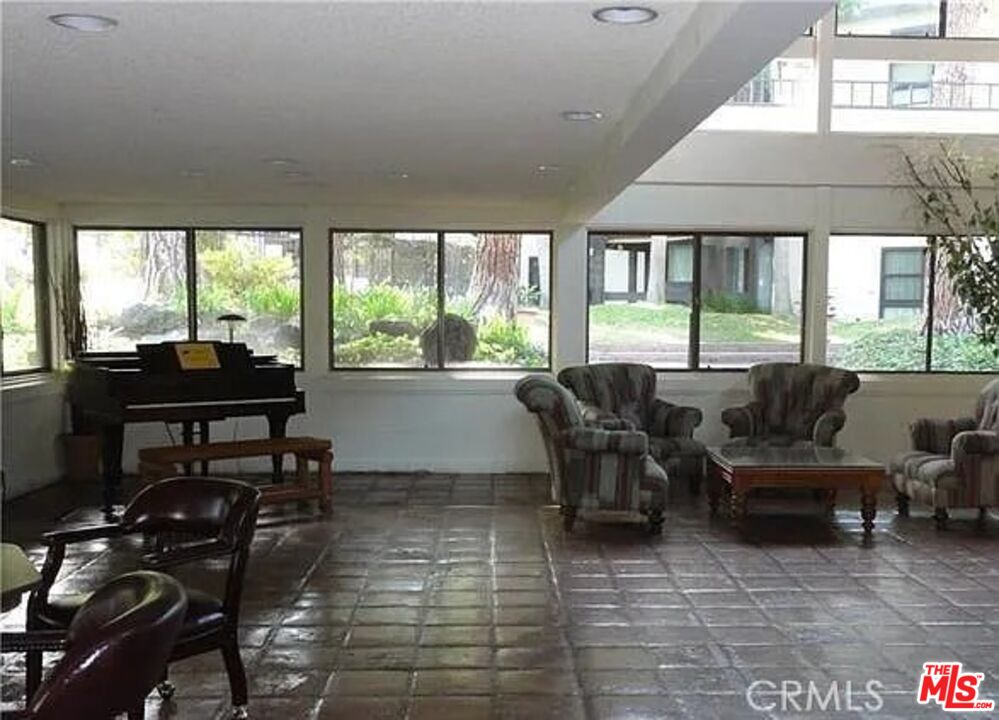 7777 West 91st Street, Unit E2143 Playa del Rey, CA 90293 - Photo 20 of 21 a living room with furniture and a floor to ceiling window