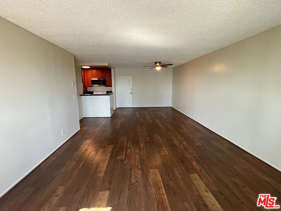7777 West 91st Street, Unit E2143 Playa del Rey, CA 90293 - Photo 4 of 21 a view of a room with wooden floor