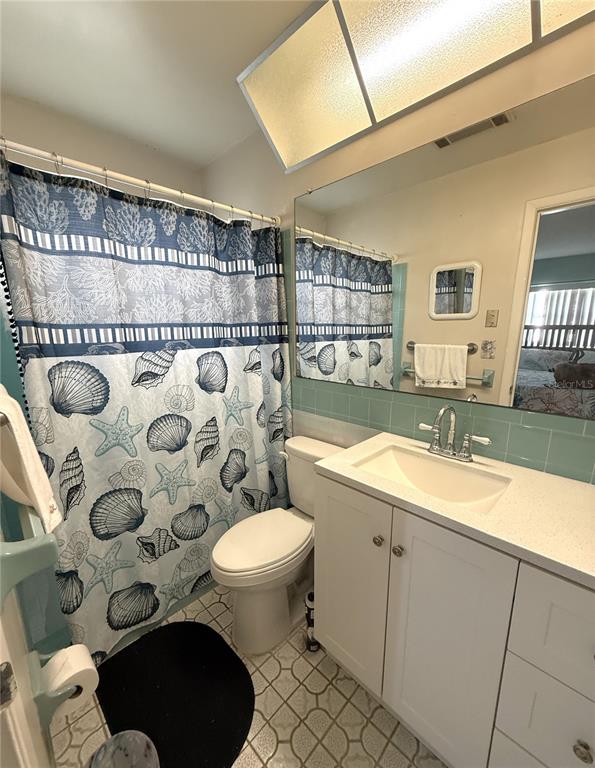 10171 45th Way Pinellas Park, FL 33782 - Photo 11 of 45 a bathroom with a granite countertop toilet sink and mirror