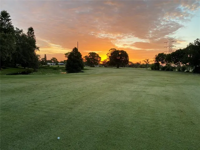 a view of a field with an trees in the background