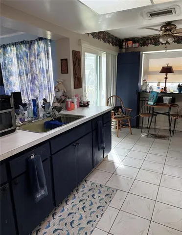 a kitchen with a sink window and cabinets