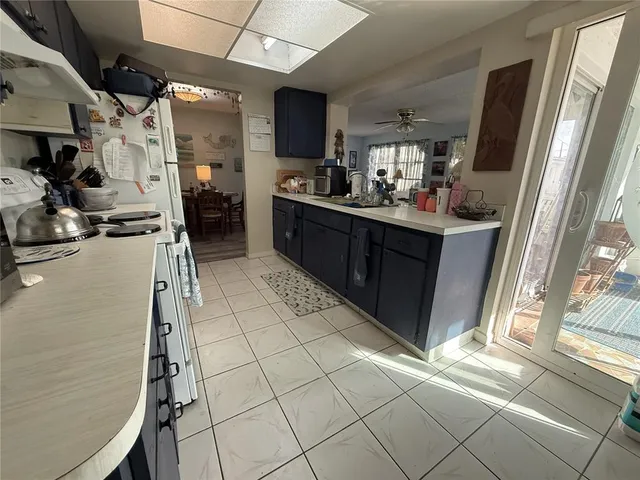 a kitchen with stainless steel appliances a sink and a refrigerator
