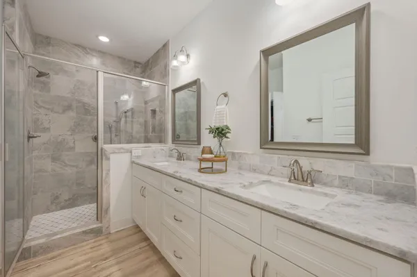 a bathroom with double sink and a mirror